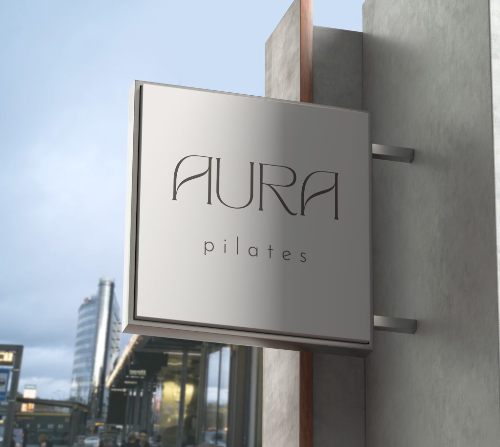 aura pilates mockup of a shop front signage